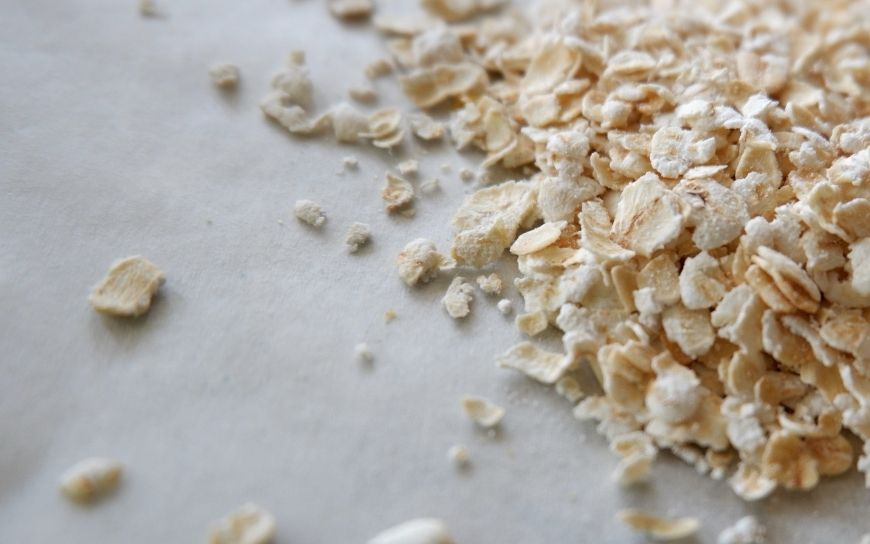 Face mask with egg, honey and oat Oat flakes on a table