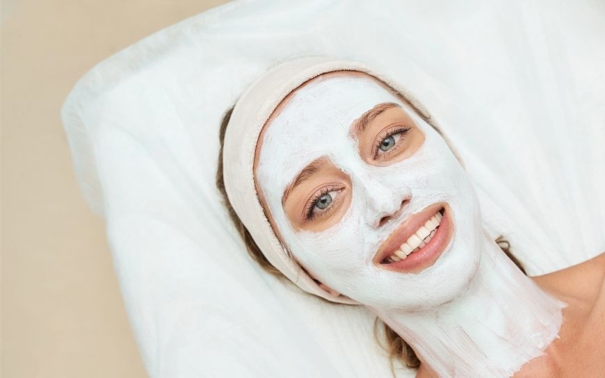 A woman wearing a white beauty face mask