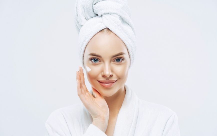 Woman applying a face cream
