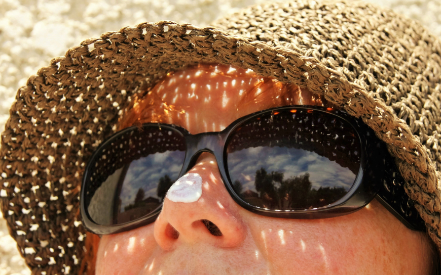 Protect your eyes from the sun Woman wearing hat and sunglasses