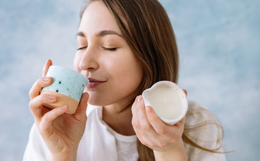 Soy candles smell better Woman smelling two candles