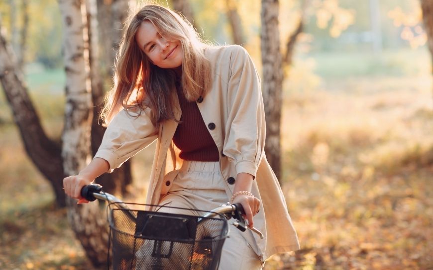 Skin Care Products you Should be Using in your 30’s Woman in her 30's on a bicycle