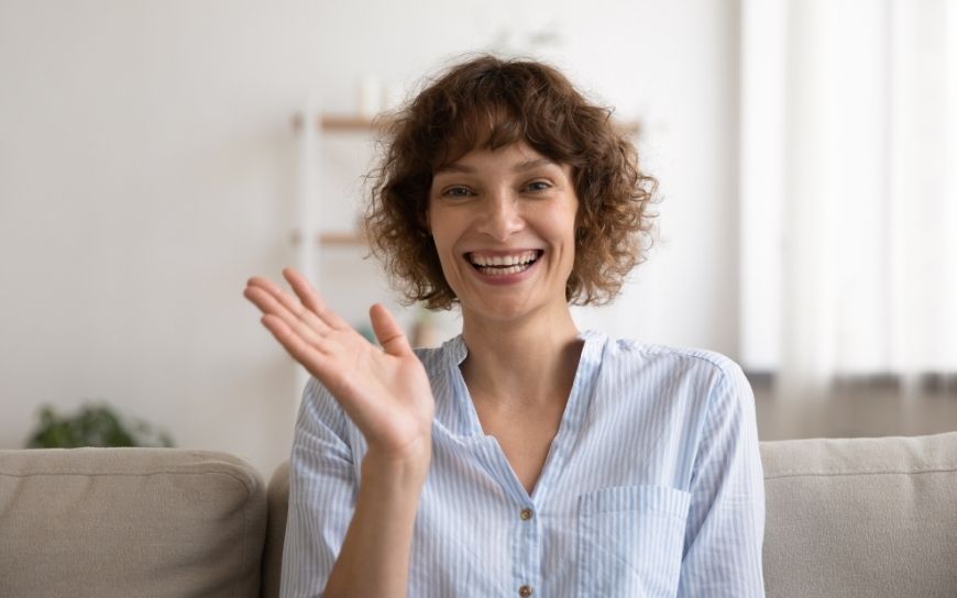 Skin Care Products you Should be Using in your 40’s Woman in her 40's smiling and waving