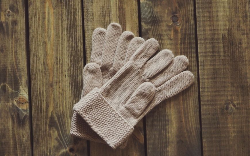 A pair of gloves on a wooden surface