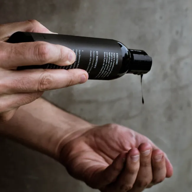 Body wash poured into a man's hand