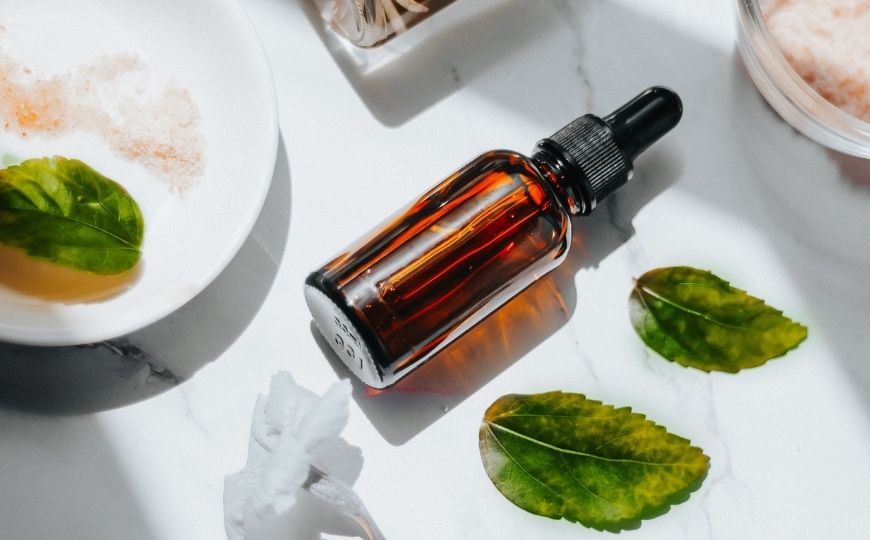 A serum and natural ingredients on a table