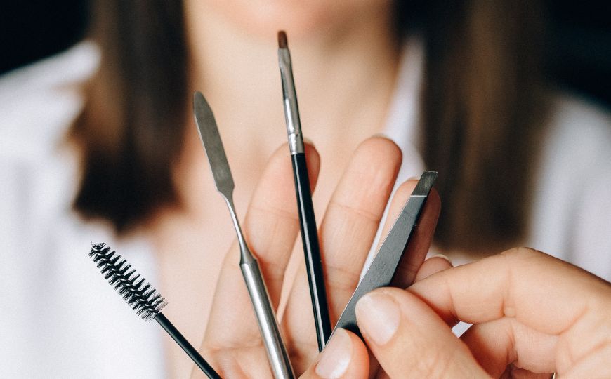 A woman holding make up tools